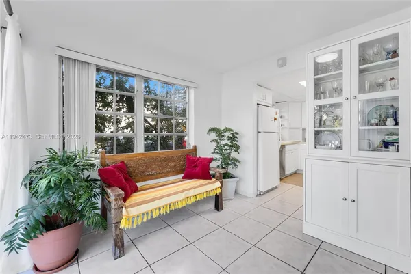a living room with furniture and flowers