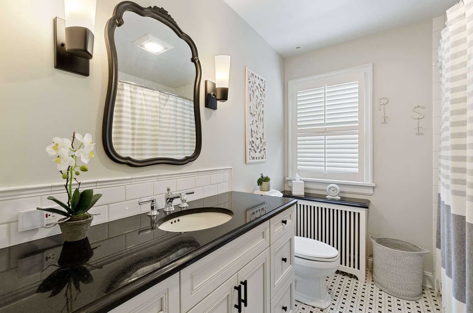 514 Meadow Road Winnetka, IL 60093 - Photo 20 of 31 a bathroom with a granite countertop toilet sink and mirror