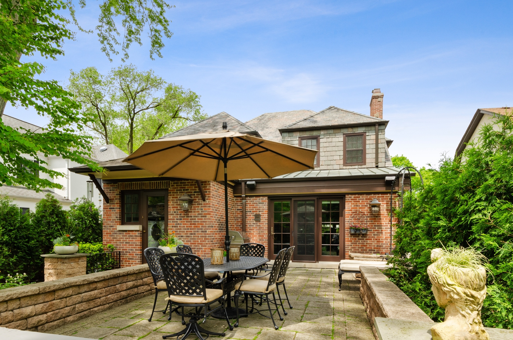 514 Meadow Road Winnetka, IL 60093 - Photo 25 of 31 a view of a house with table and chairs under an umbrella