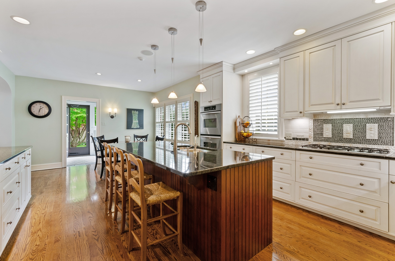 514 Meadow Road Winnetka, IL 60093 - Photo 7 of 31 a kitchen with stainless steel appliances granite countertop a stove a sink dishwasher and a refrigerator with wooden floor