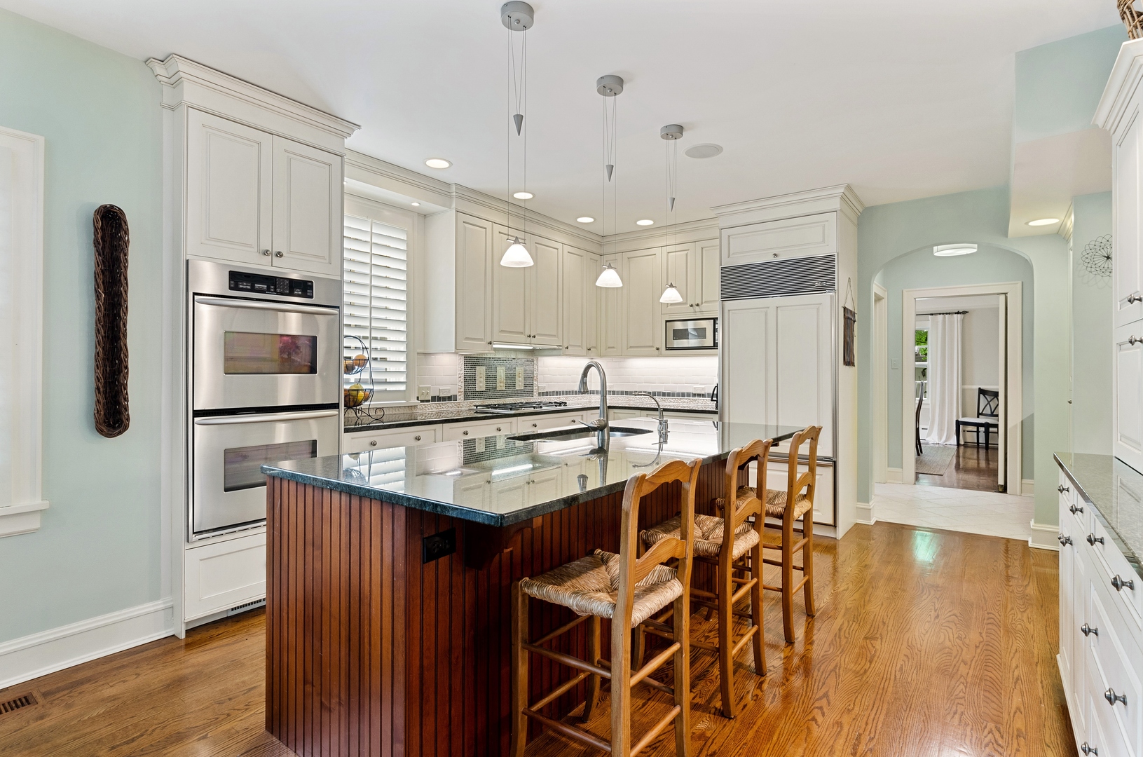 514 Meadow Road Winnetka, IL 60093 - Photo 8 of 31 a kitchen with stainless steel appliances kitchen island granite countertop a refrigerator and a stove top oven