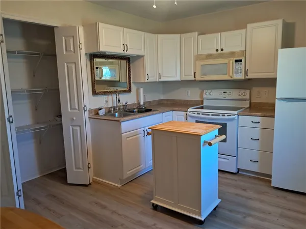 a kitchen with stainless steel appliances a stove cabinets and wooden floor