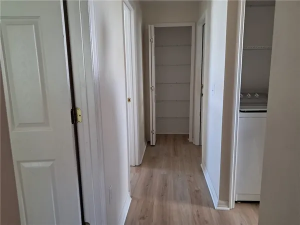 a view of a hallway with wooden floor