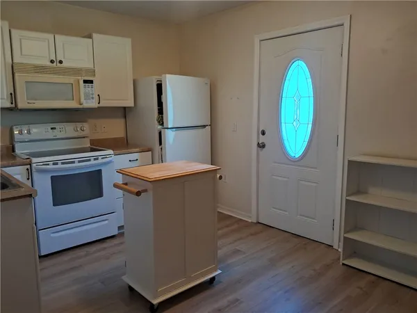 a kitchen with a stove top oven and a refrigerator