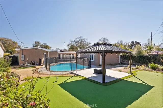 a view of a swimming pool with a garden and plants