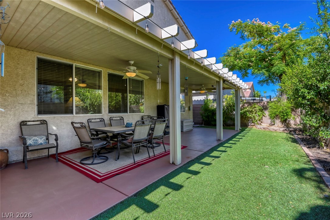 2356 Tilden Way Henderson, NV 89074 - Photo 26 of 30 An inviting covered patio with an outdoor dining area, perfect for alfresco meals and relaxation.