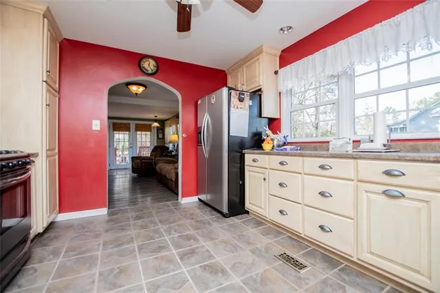 a very nice looking room with many windows and furniture