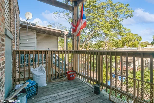 a view of a balcony with chair and wooden floor