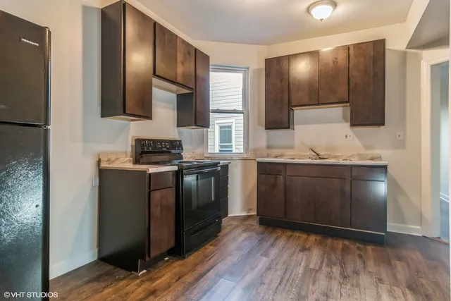 a kitchen with granite countertop a stove and a refrigerator