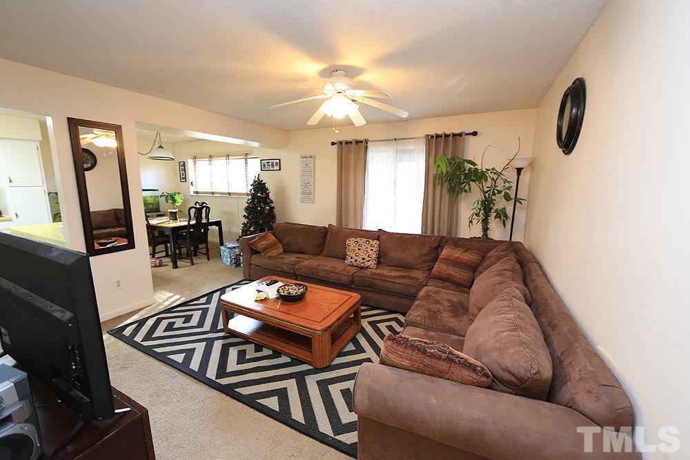 524 Pine Ridge Place, Unit 524 Raleigh, NC 27609 - Photo 2 of 12 a living room with furniture and a chandelier