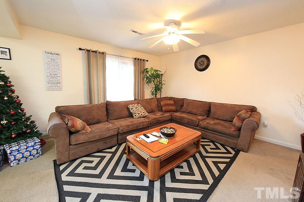 524 Pine Ridge Place, Unit 524 Raleigh, NC 27609 - Photo 3 of 12 a living room with furniture and a chandelier