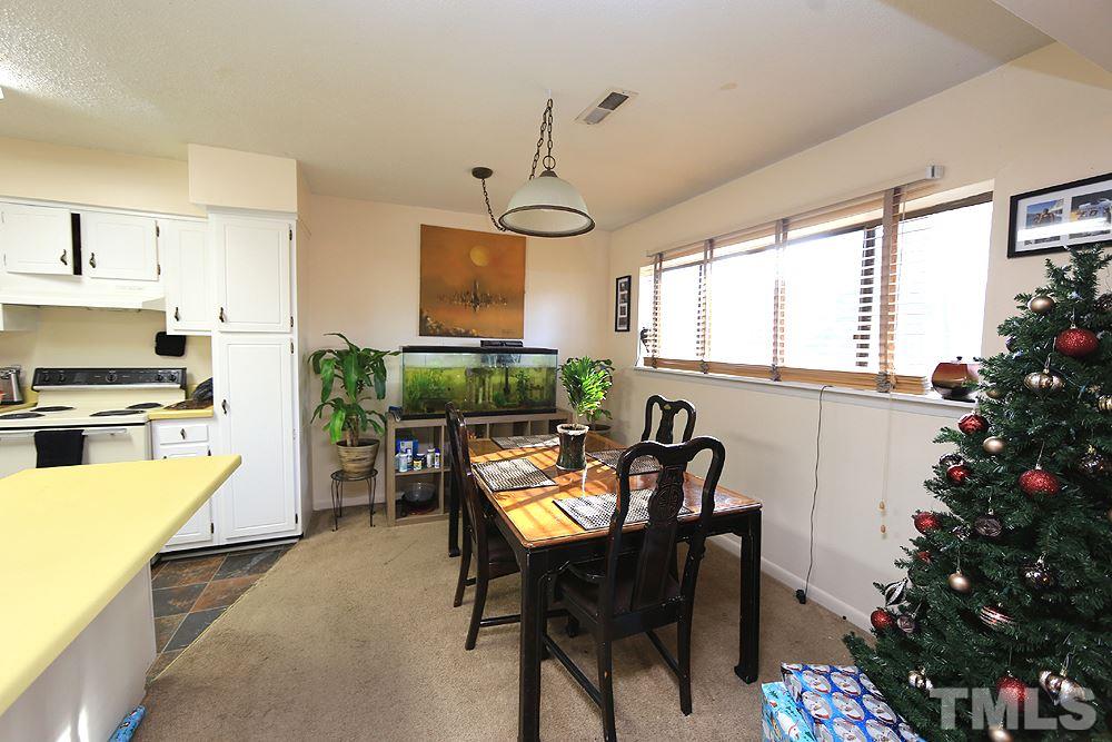 524 Pine Ridge Place, Unit 524 Raleigh, NC 27609 - Photo 5 of 12 a view of a dining room with furniture window and outside view