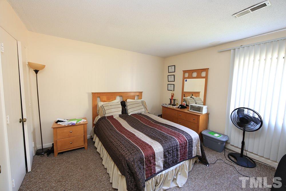 524 Pine Ridge Place, Unit 524 Raleigh, NC 27609 - Photo 7 of 12 a bedroom with a bed and a window