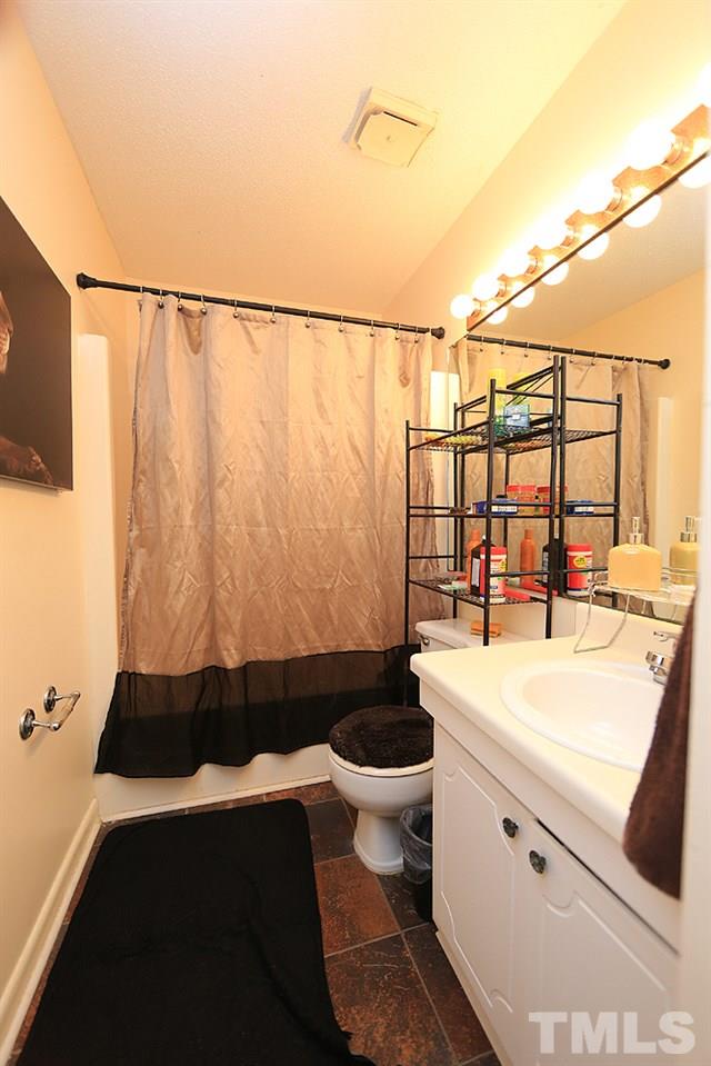 524 Pine Ridge Place, Unit 524 Raleigh, NC 27609 - Photo 8 of 12 a bathroom with a sink and mirror