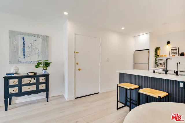 a dining room with chairs and wooden floor