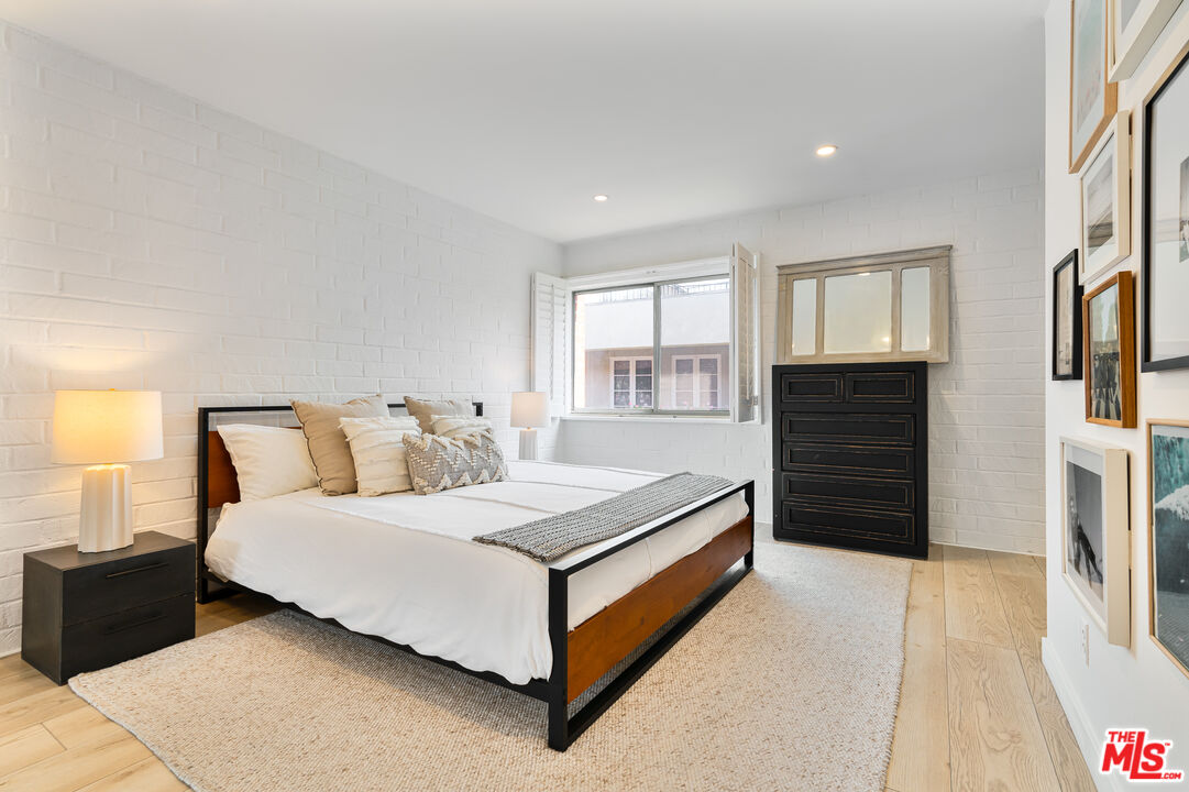 11750 Sunset Boulevard, Unit 407 Los Angeles, CA 90049 - Photo 10 of 12 a bedroom with a bed and a dresser