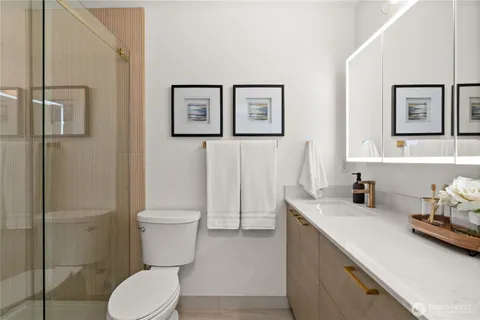 a bathroom with a toilet a sink and shower