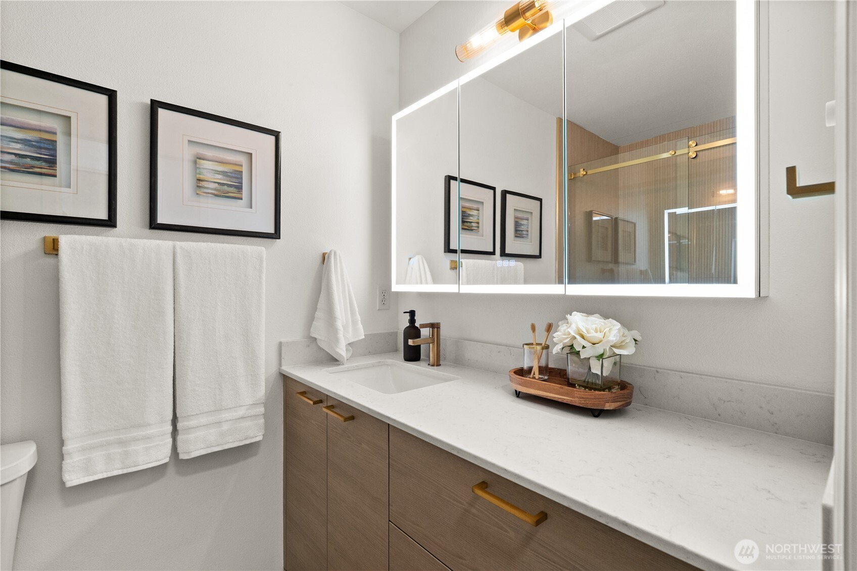 23210 Fitzgerald Road, Unit 2 Bothell, WA 98021 - Photo 15 of 26 a bathroom with a sink mirror and painting on the wall