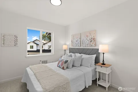 a bedroom with a bed and lamp