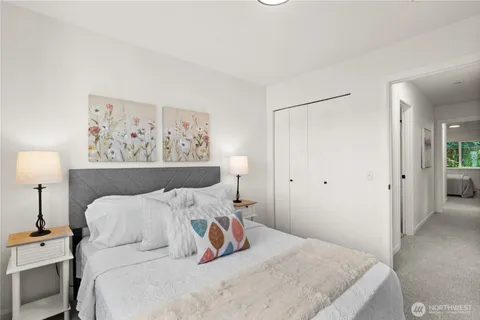 a bedroom with a bed and a lamp on table