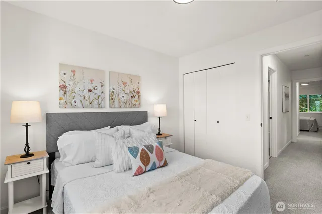 a bedroom with a bed and a lamp on table