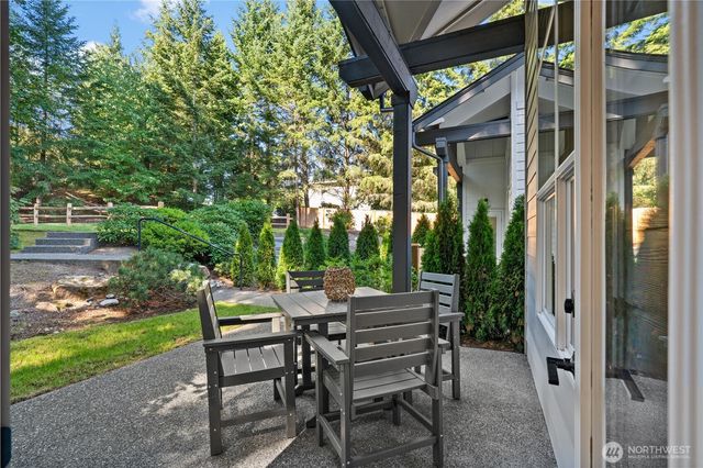 a view of a patio with table and chairs and potted plants