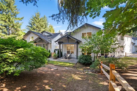 a front view of a house with yard and green space