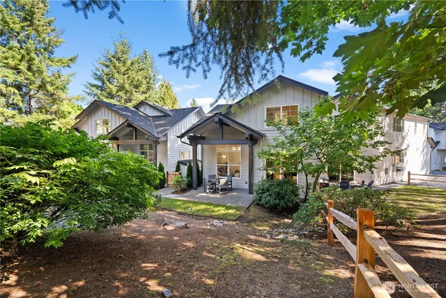 a front view of a house with yard and green space