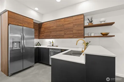 a kitchen that has a sink stainless steel appliances and cabinets