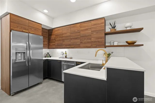a kitchen that has a sink stainless steel appliances and cabinets