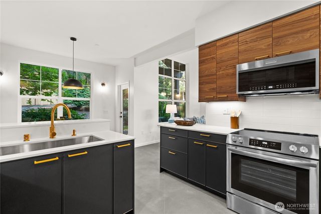 a kitchen with a sink stove and microwave