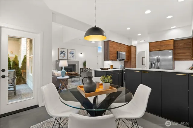 a dining room with furniture a rug a potted plant and a chandelier
