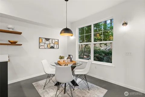 a dining room with furniture a rug and a window