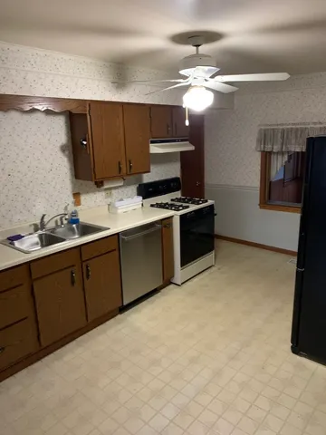 a kitchen with sink cabinets and window