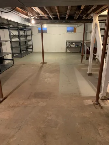 a view of a yard in front of a house with a large tree