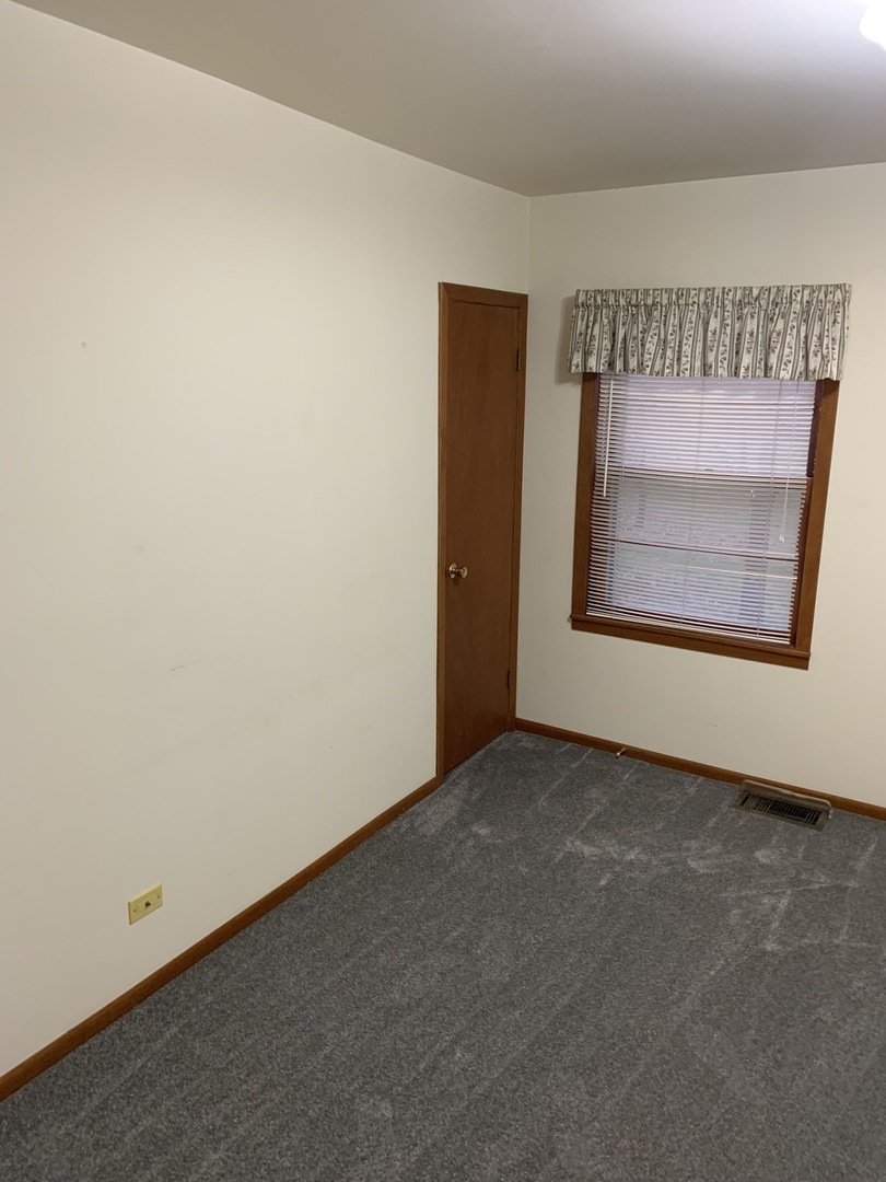 37W793 Binnie Road, Unit 1 Dundee, IL 60118 - Photo 7 of 23 an empty room with a bench