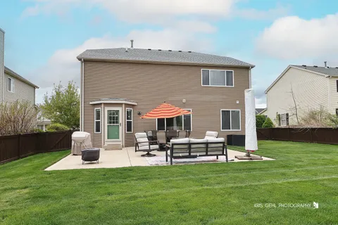 a front view of house with yard and outdoor seating
