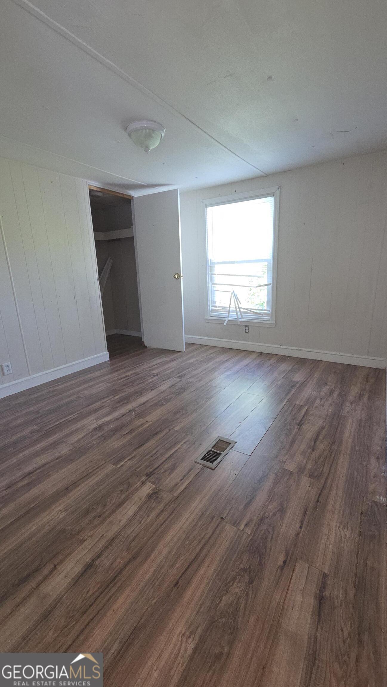 25 Fischer Road Sharpsburg, GA 30277 - Photo 15 of 22 a view of empty room with wooden floor and fan