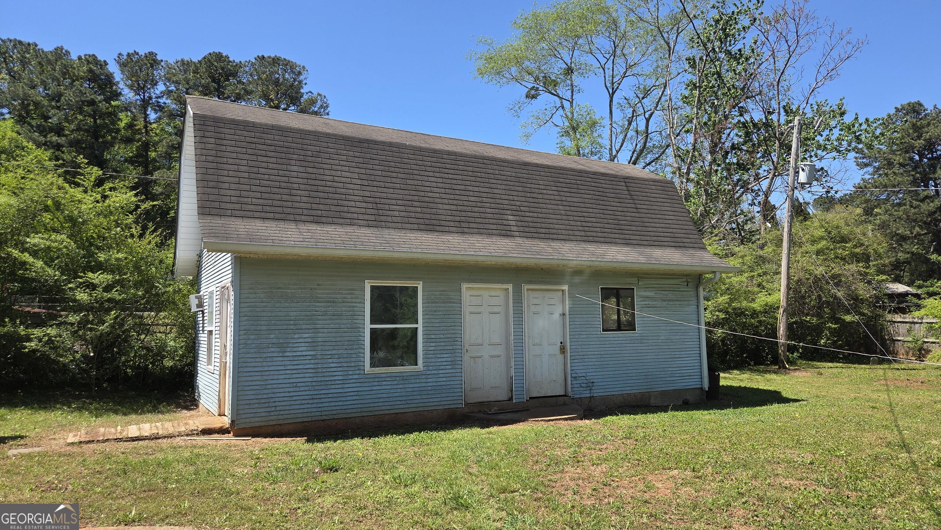 25 Fischer Road Sharpsburg, GA 30277 - Photo 19 of 22 a front view of a house with a yard
