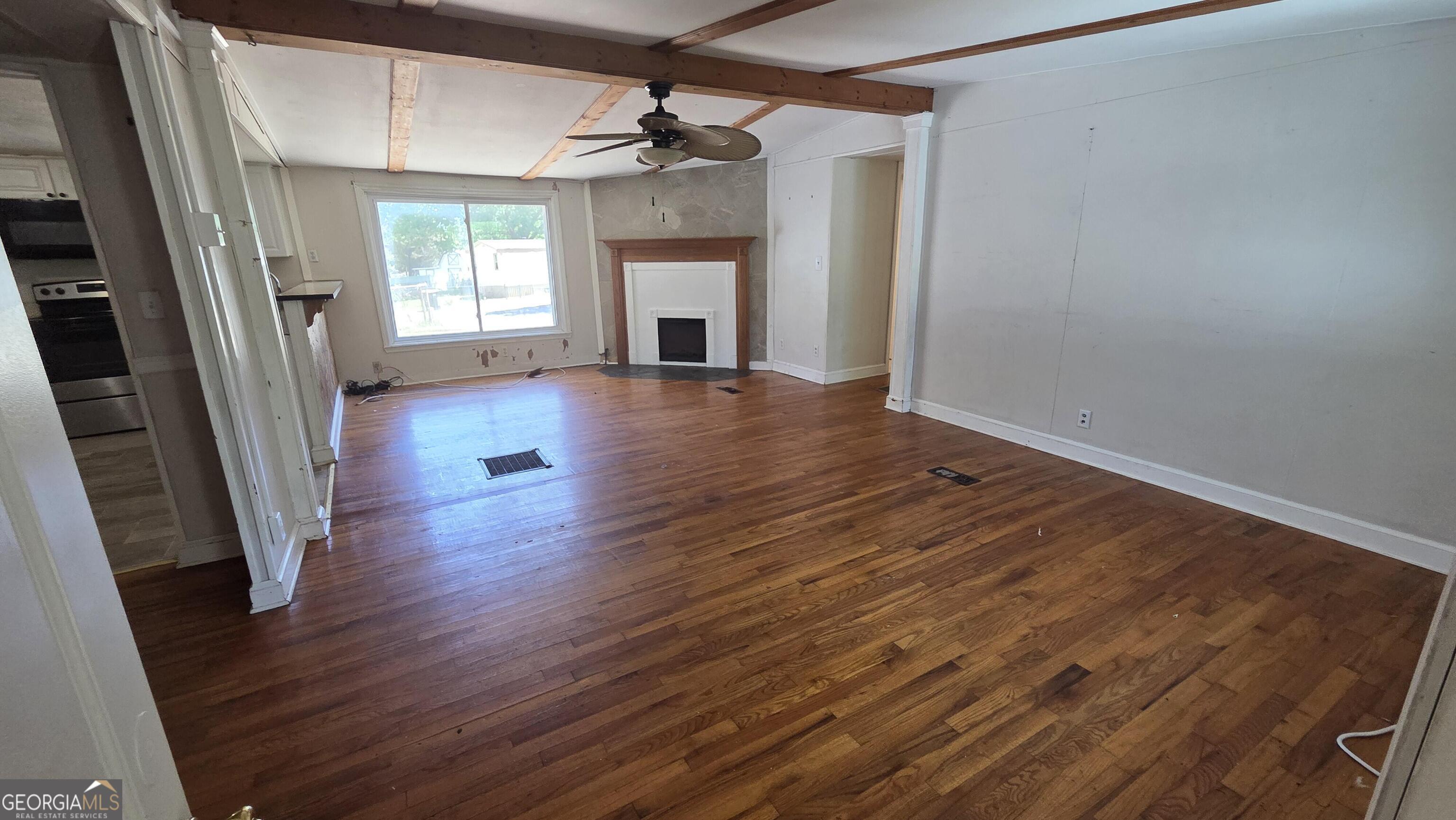 25 Fischer Road Sharpsburg, GA 30277 - Photo 5 of 22 wooden floor in an empty room with a window