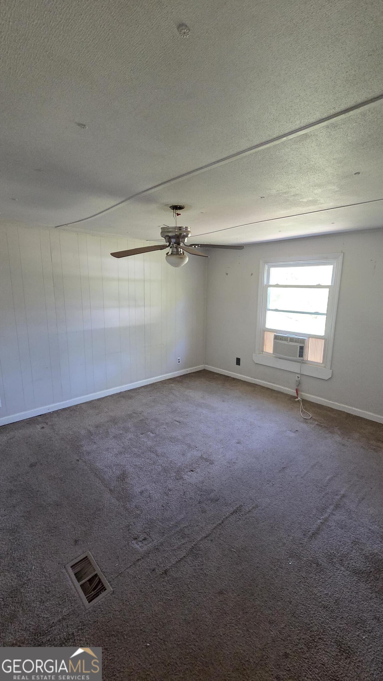 25 Fischer Road Sharpsburg, GA 30277 - Photo 8 of 22 an empty room with a empty space and windows