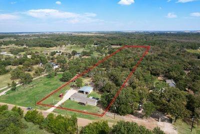 8055 County Road, Unit 301 Terrell, TX 75160 - Photo 3 of 8 an aerial view of residential houses with outdoor space and trees
