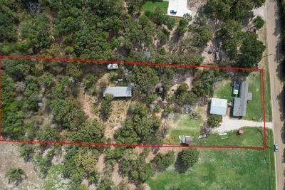 8055 County Road, Unit 301 Terrell, TX 75160 - Photo 5 of 8 an aerial view of residential house with outdoor space and trees all around