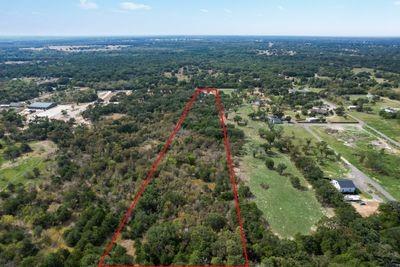 8055 County Road, Unit 301 Terrell, TX 75160 - Photo 6 of 8 an aerial view of residential houses with outdoor space and trees