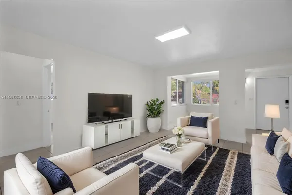 a living room with furniture and a flat screen tv