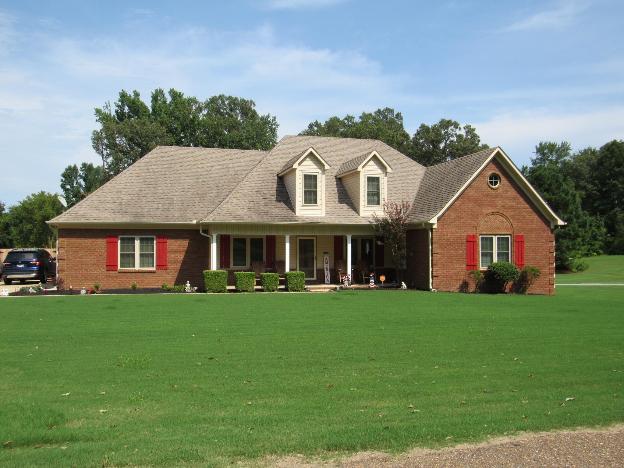 a front view of a house with a yard