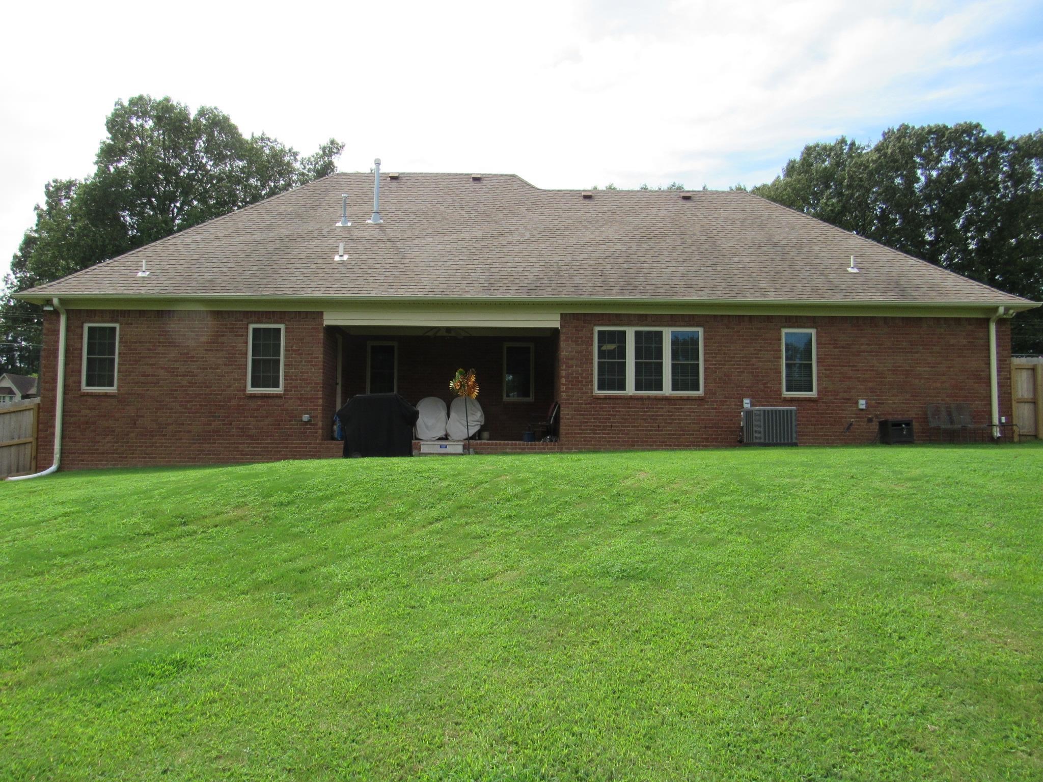 498 McQuiston Road Brighton, TN 38011 - Photo 13 of 17 a view of a house with backyard porch and garden