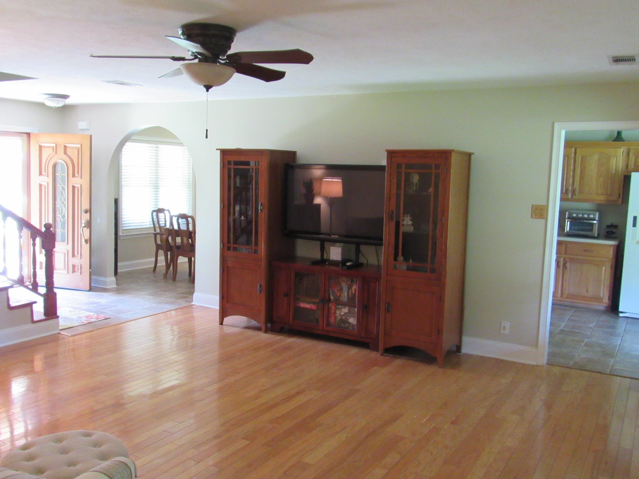 498 McQuiston Road Brighton, TN 38011 - Photo 17 of 17 a view of a room with wooden floor a ceiling fan and windows
