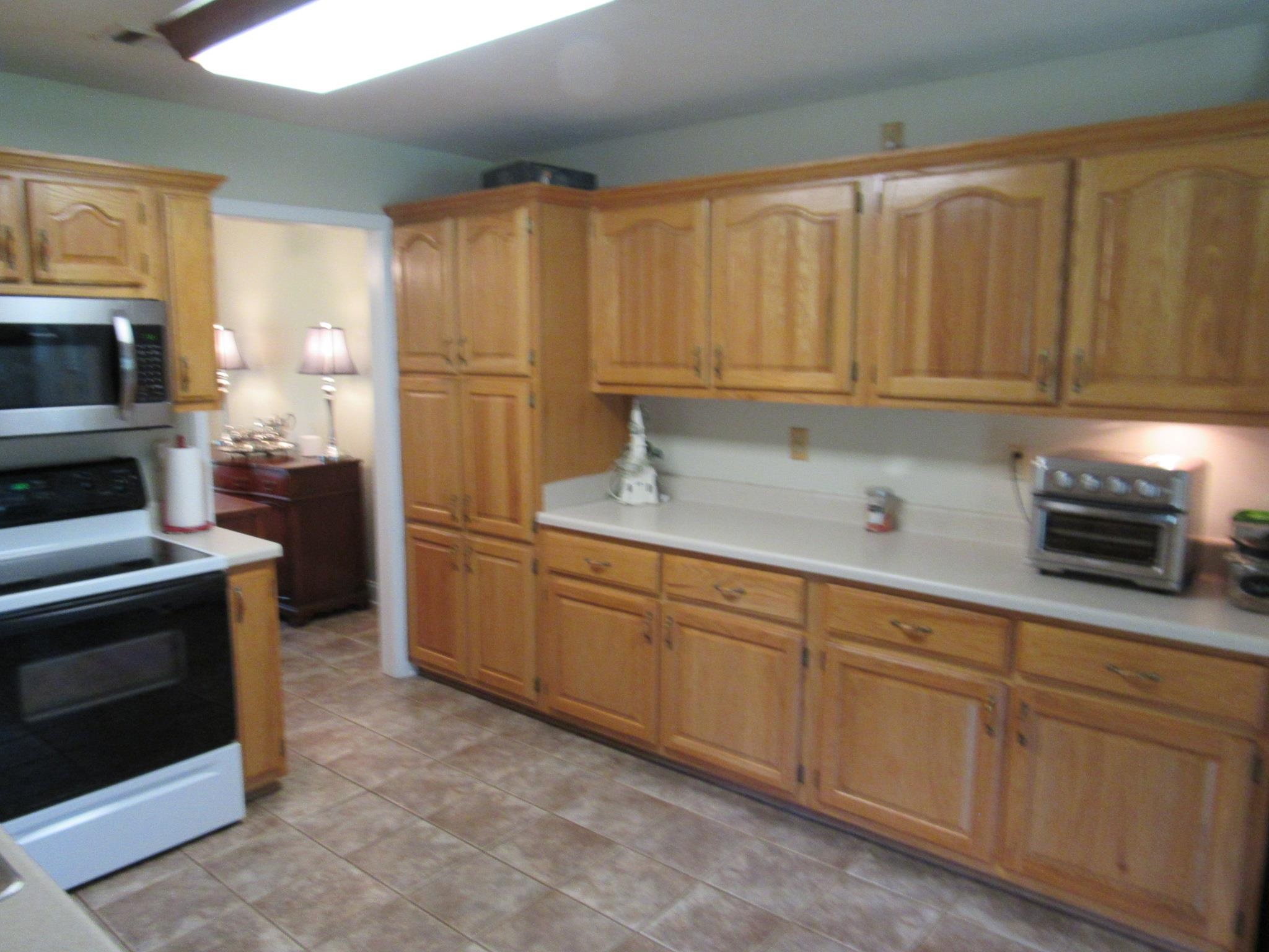 498 McQuiston Road Brighton, TN 38011 - Photo 7 of 17 a kitchen with granite countertop cabinets stainless steel appliances and a sink