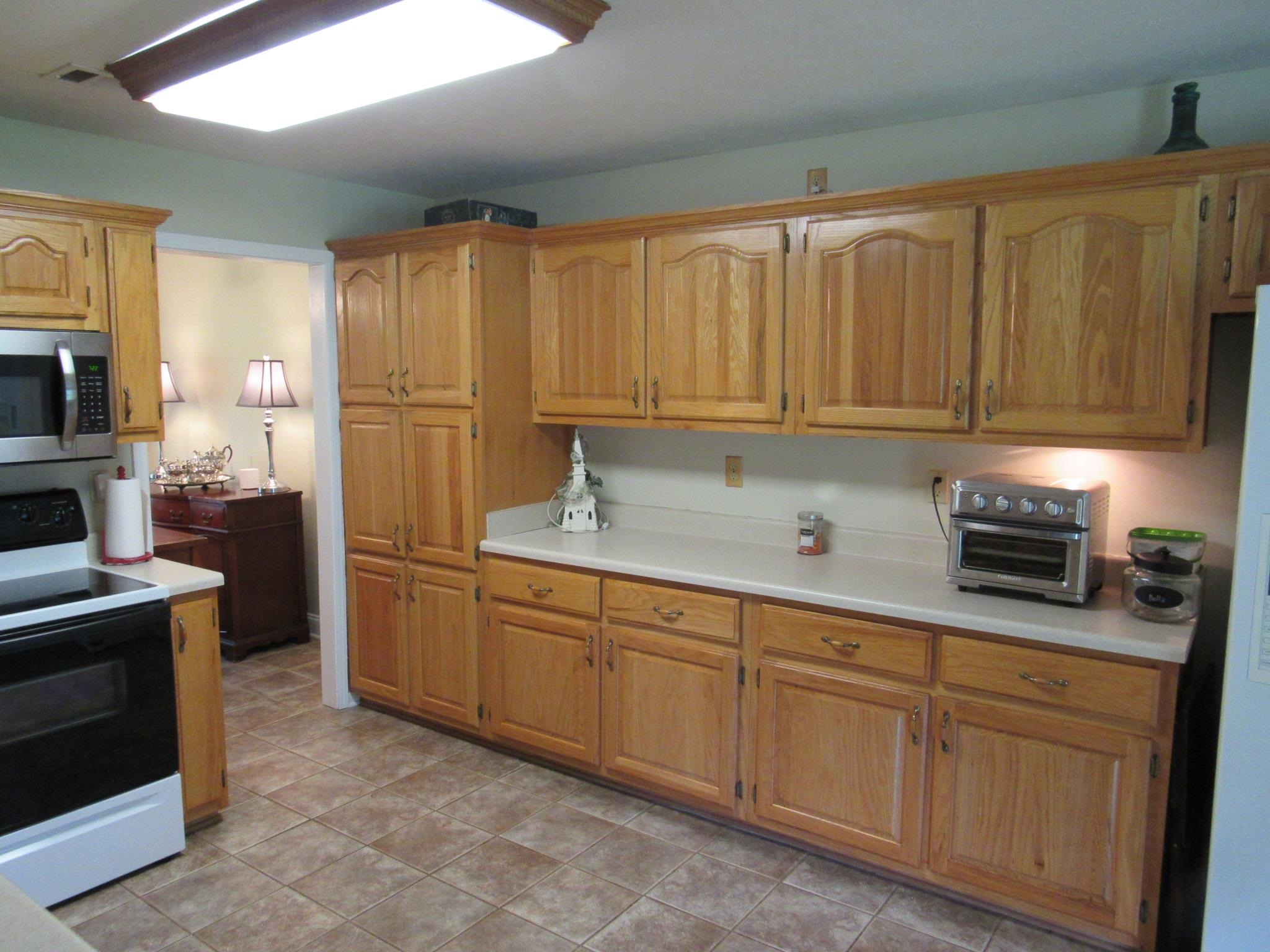 498 McQuiston Road Brighton, TN 38011 - Photo 8 of 17 a kitchen with stainless steel appliances granite countertop a stove a sink and a refrigerator